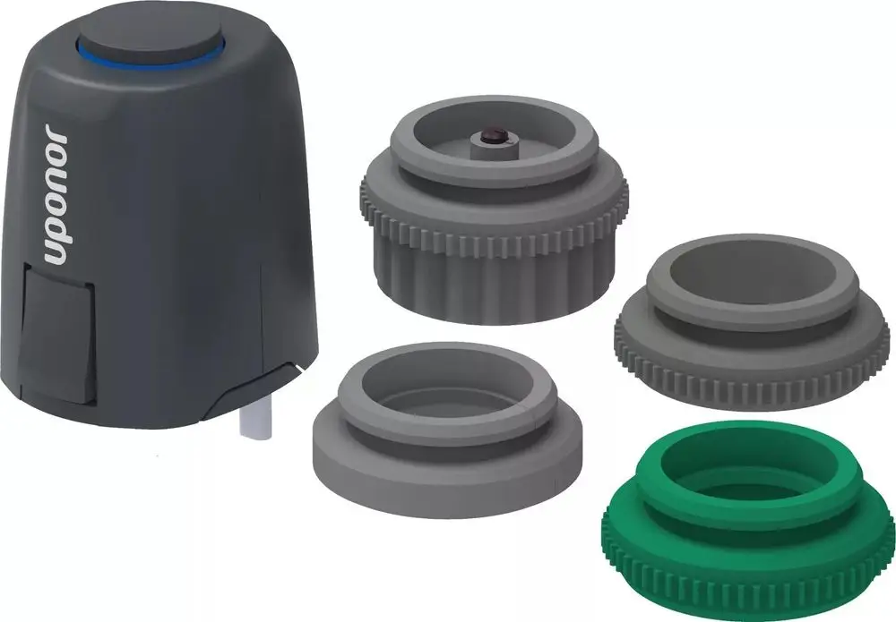 Uponor Vario Stellantrieb mit mehreren austauschbaren Adaptern in grauer und grüner Farbe, geeignet für unterschiedliche Installationen.